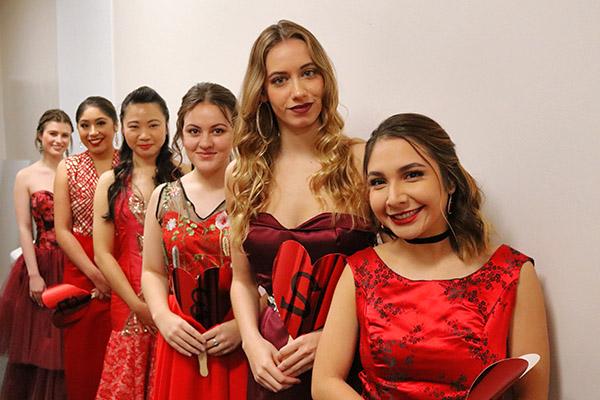 Fashion models standing in line at the Red Dress Fashion Show